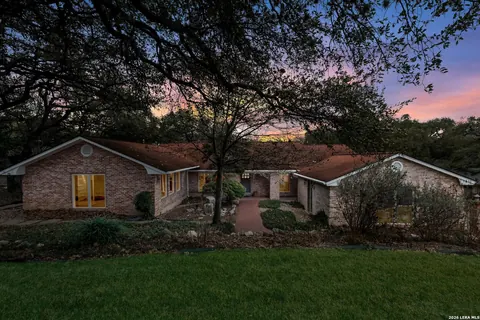 Hollywood Park - dusk exterior of a brick ranch-style home