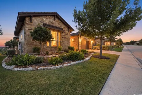 La Cantera - dusk exterior of a stone cottage-style home