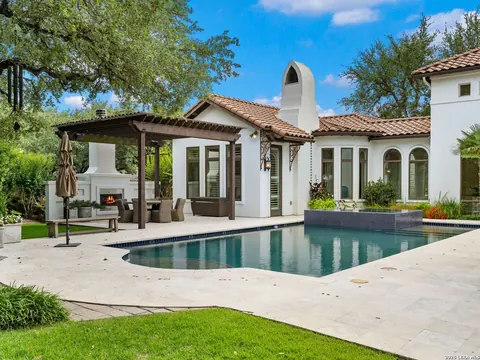 Shavano Park - backyard pool and covered outdoor living area with a fireplace