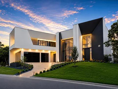 The Dominion - dusk exterior of a modern black and white home