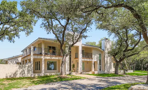 Hill Country Village - side exterior of a modern home among oak trees